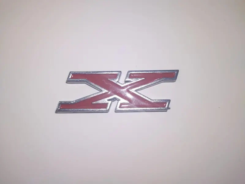 Fender, Hood Emblem, Deck Emblem "X", 2"X1.75", 1971-78 Gremlin X, 1972-76 Hornet X, 1974-75 Matador X, 1975-77 Pacer X 1